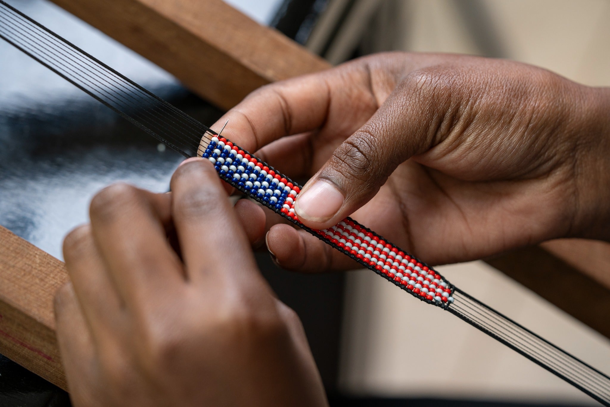 A Fahari bracelet being created bead by bead